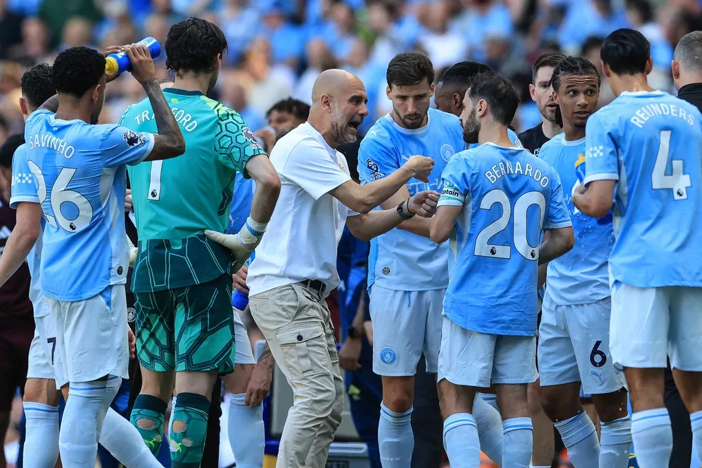 HLV Pep Guardiola trao đổi với tiền vệ Bernardo Silva trong quãng nghỉ uống nước ở trận Man City gặp Aston Villa trên sân Etihad, vòng cuối Ngoại hạng Anh ngày 24/5/2026. Ảnh: AFP