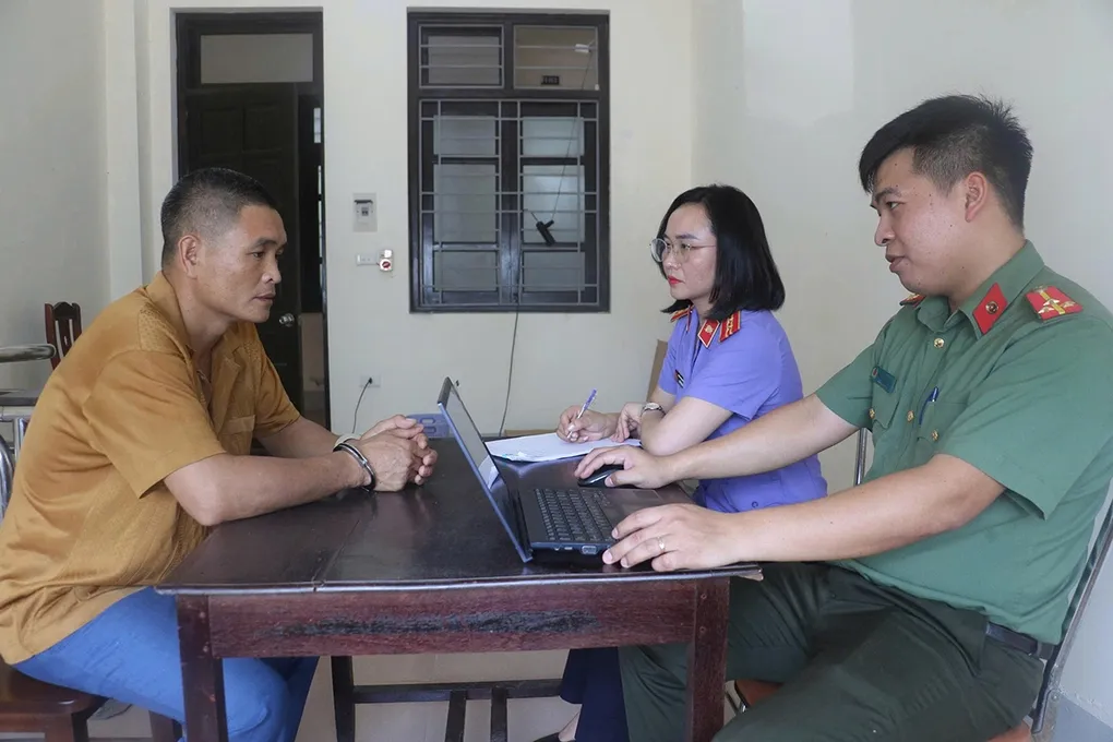 Nghi can Kiên (góc phải) làm việc với cơ quan điều tra. Ảnh: Hòa Vang