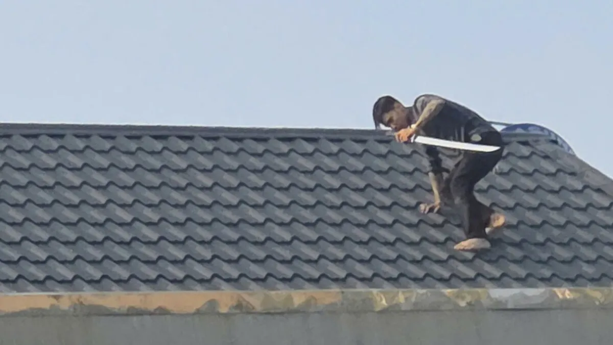Hai người cầm kiếm cố thủ trên mái nhà là bị can ma túy đang bỏ trốn